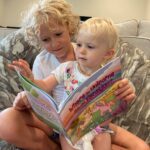 siblings reading Where do Unicorns go on vacation