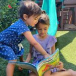 two kids reading Where do Dinosaurs go on vacation