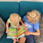 top view of two kids reading a picture book